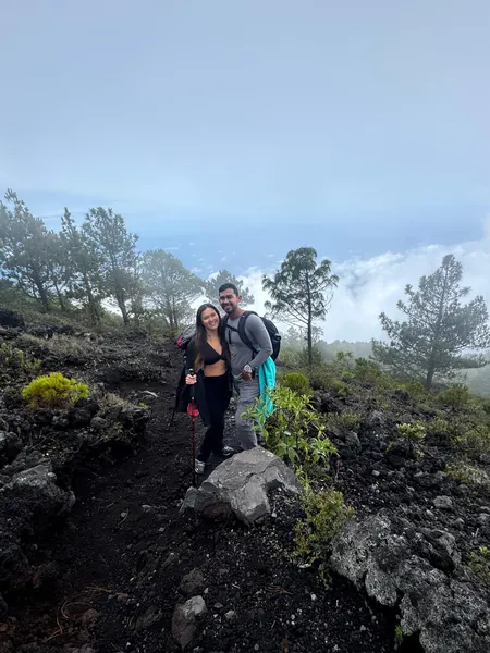 Rousse and Kaleb from Alegria Trips on a volcanic trail above the clouds