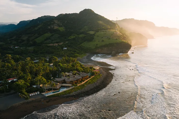 Aerial view of the green coast and waves of Mizata at sunrise
