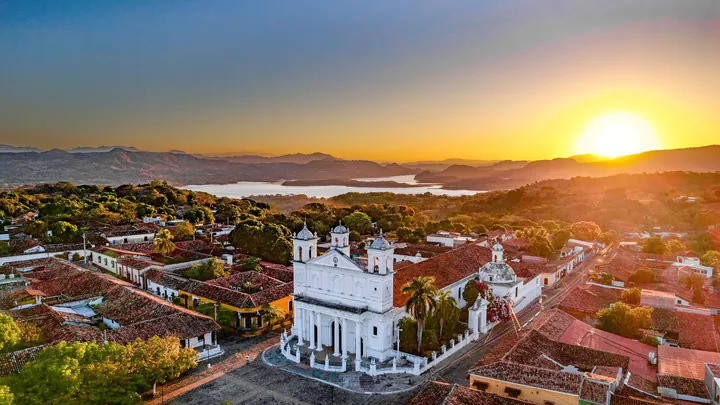 Sunset over the colonial town of Suchitoto and its white church